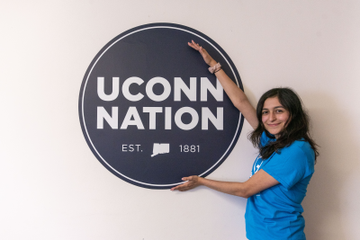excited student posing with the UConn Nation logo